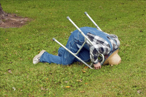 elderly man with a walker takes a tumble in the park